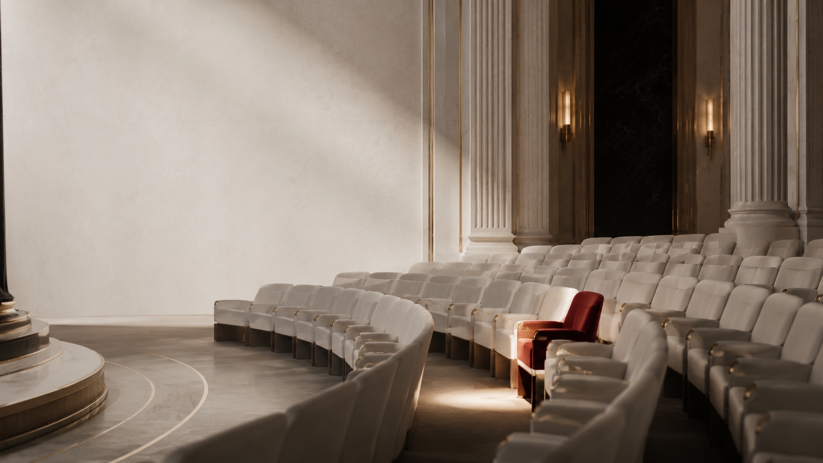 An ivory auditorium with one Monarch Red seat among rows of ivory seats.